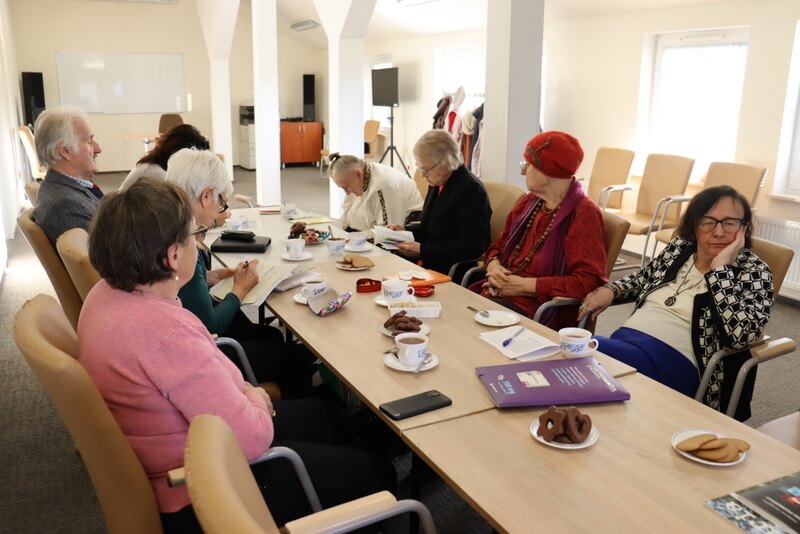 Grupa ludzi siedzących przy stole